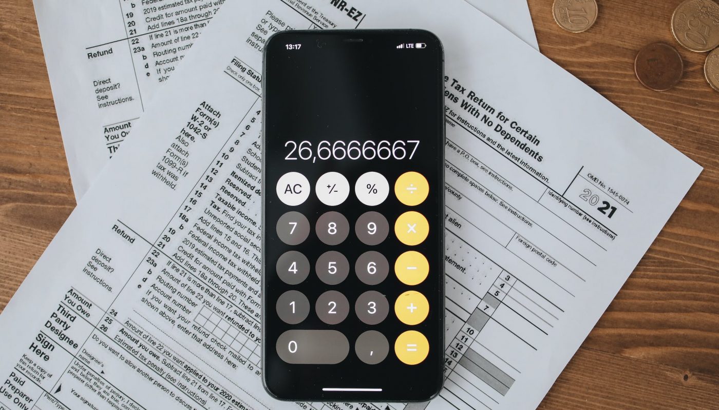 Tax Forms With Calculator On Wooden Surface